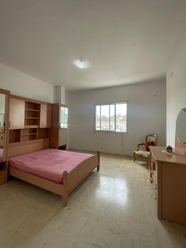a large bedroom with a bed and a desk at Spacious two room apartment with a super view in Bizerte