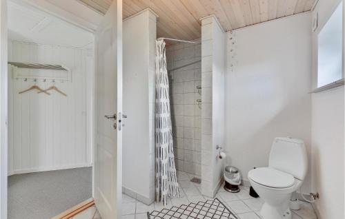 a white bathroom with a toilet and a shower at Holiday Home Hvide Sande 24 in Bjerregård