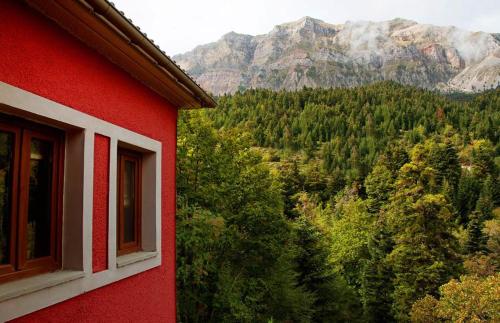 a red building with a view of a mountain at Agathi in Pramanta