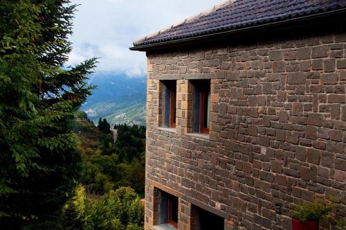 a brick building with windows on the side of it at Agathi in Pramanta