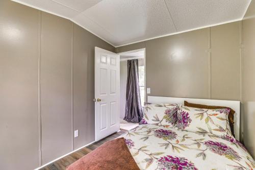 a bedroom with a bed with flowers on it at Elloree Vacation Rental about 7 Mi to Lake Marion! in Santee