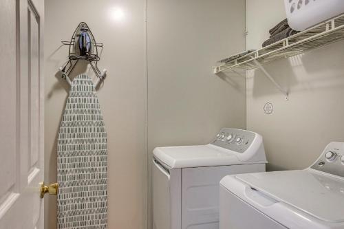a small laundry room with a washer and dryer at Elloree Vacation Rental about 7 Mi to Lake Marion! in Santee