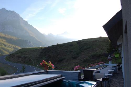 a balcony with a view of a winding mountain road at Gîte Chalet du Soulor in Arrens-Marsous