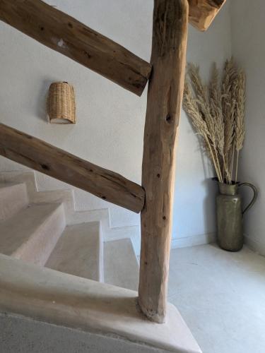 a wooden stair case with a light on the top at Aghroud bay house in Agadir