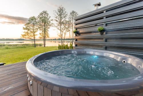 a hot tub on the deck of a house at Comfort Villas in Ukmergė