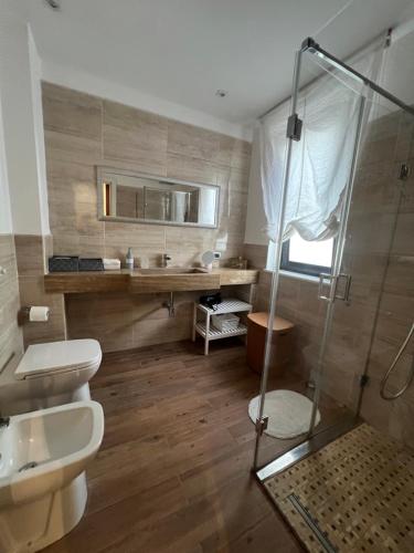 a bathroom with a shower and a toilet and a sink at Villa Losanna in Mondello