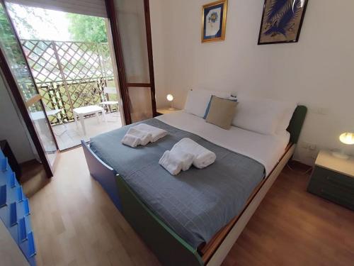 a bedroom with a bed with two pillows on it at easy home Lake in Arona