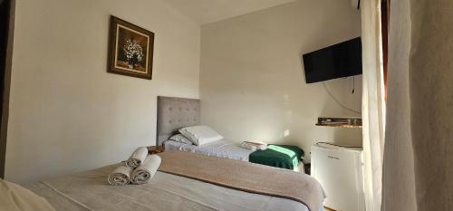 a room with two beds and a television in it at GH Bizkaia in Florianópolis