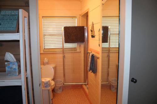 a small bathroom with a toilet and two sinks at Cabin Three On Stony Point in Jay
