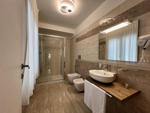 a bathroom with two toilets and a sink and a shower at Dimore Relais - Suite Garden Breakfast in Porto Cesareo