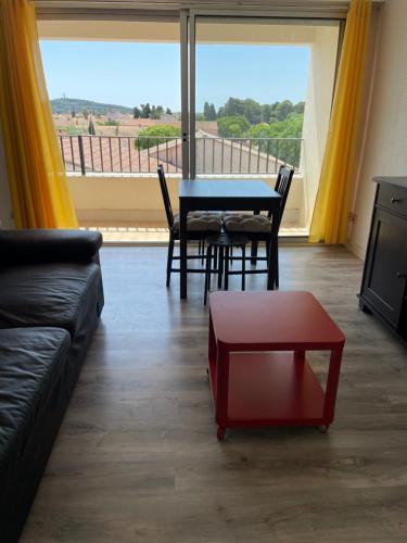 a living room with a couch and a table at Résidence Agathoise in Agde