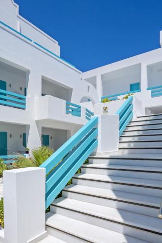 a building with blue and white stairs at Santellini Hotel in Kamari