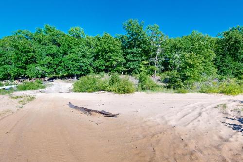 a tree branch laying on the sand on a beach at JJ's Great Escape in Eufaula