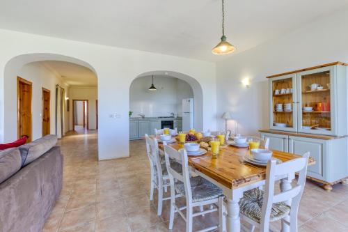 a dining room with a table and a couch at Ta Frenc Apartments in Għasri