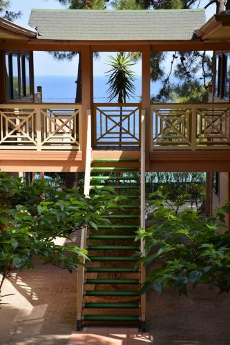 a staircase leading up to a house with a balcony at Résidence Les Pins in Calvi