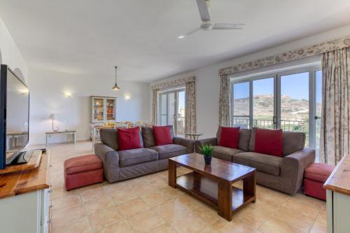 a living room with two couches and a table at Ta Frenc Apartments in Għasri