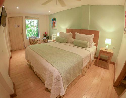 a bedroom with a large bed in a room at Posada La Fe in Cartagena de Indias