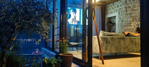 a woman laying on a couch in a living room at Monte Bay Retreat Villa in Perast