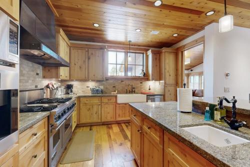 a kitchen with wooden cabinets and a counter top at Mount Olympia Oasis in South Lake Tahoe