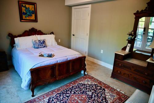 a bedroom with a bed and a dresser at James Armistead Lafayette Cottage in Cumberland Landing