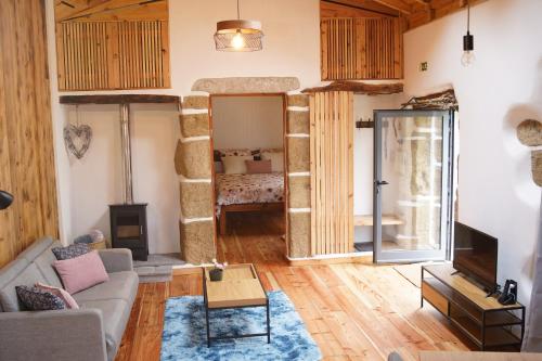 a living room with a couch and a fireplace at Casa Azorina - Casas Florescer in Fajazinha