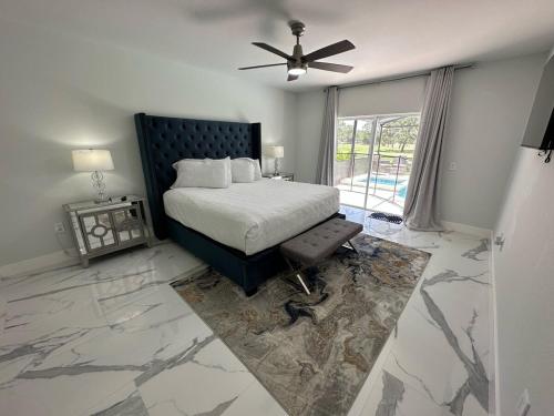 a bedroom with a bed and a ceiling fan at Beautifully Remodeled Home - Southen Dunes Golf Course Views in Haines City