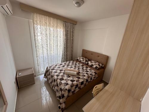 a small bedroom with a bed and a window at Kyrenia center, 2 bedroom, 1 living room, residential apartment in Kérynia
