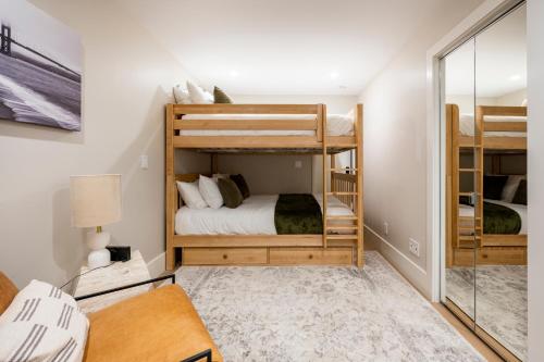 a bedroom with two bunk beds and a mirror at Modern Luxury 3 BR Near Presidio & GG Park in San Francisco