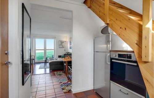 a kitchen with a refrigerator and a dining room at Gorgeous Apartment In Lemvig in Lemvig