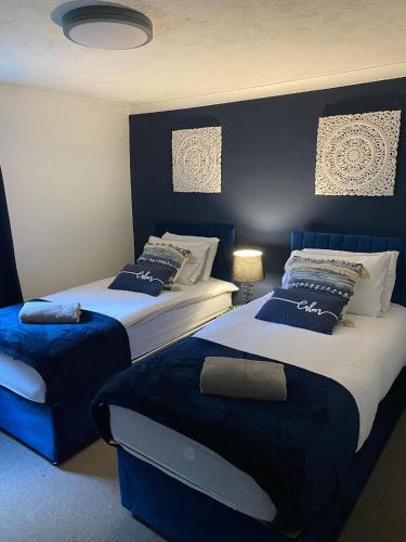 two beds in a room with blue and white at Prettide Suite - Free Parking in Gillingham