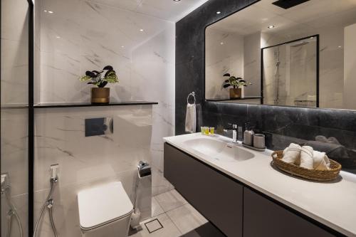 a bathroom with a sink and a mirror at Chic studio near metro at Discovery Gardens in Dubai