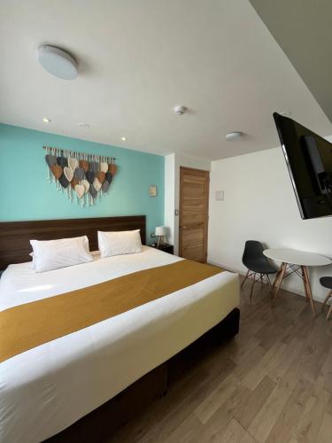 a bedroom with a large bed and a tv at CASA CRISTOBAL Centenario in Cusco