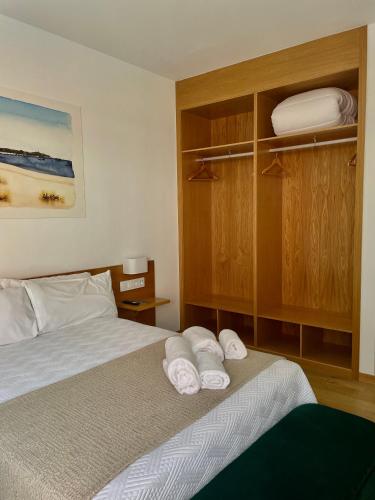 a bedroom with a bed with towels on it at HOTEL BOUTIQUE VILAVELLA in O Grove