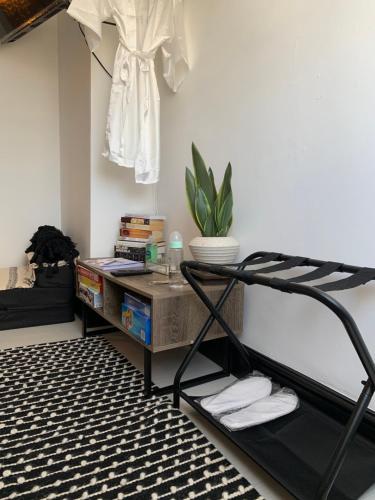a room with a bed and a table with a shelf at Sam’z Boutique in Sheffield