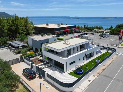an aerial view of a white building with a parking lot at Holiday Villa MI in Orebić