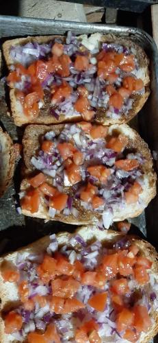 a group of three sandwiches with sauce on them at Casa Gemenelor in Cluj-Napoca