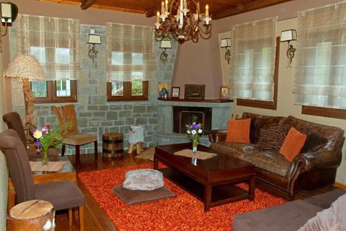 a living room with a couch and a fireplace at Agathi in Pramanta