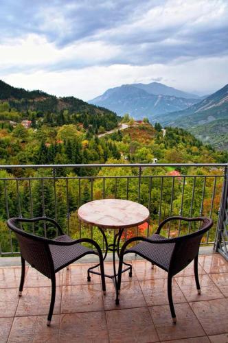 a table and chairs on a balcony with a view at Agathi in Pramanta