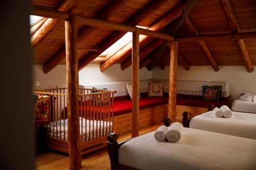 a bedroom with two beds and a crib in a room at Boutique Hotel Musée in Gjirokastër