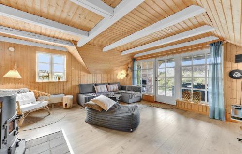 a living room with a couch and a table at Three-Bedroom Holiday Home With A Fireplace In Ringkøbing in Nørre Lyngvig
