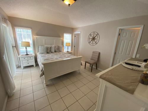 a bedroom with a bed and a table and a chair at Updated Villa with Golf Course Views - Southern Dunes in Haines City