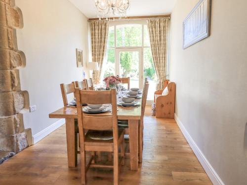 a dining room with a wooden table and chairs at Clock Tower in Grange Over Sands