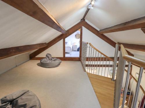 a room with wooden ceilings and a staircase at Clock Tower in Grange Over Sands