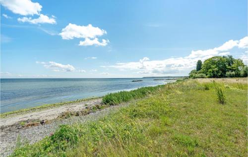 a view of a beach with the ocean in the background at 1 Bedroom Nice Home In Stege in Stege