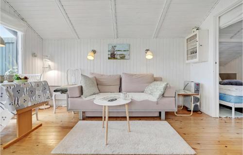 a living room with a couch and a table at 1 Bedroom Nice Home In Stege in Stege