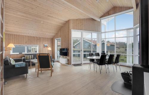 a living room with a table and chairs and a television at Holiday Home Fjand Strand Ulfborg Iv in Fjand Gårde