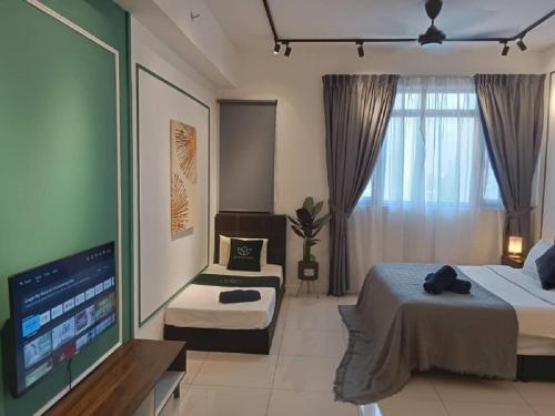 a bedroom with two beds and a flat screen tv at Cherry Homes at Chambers Kuala Lumpur in Kuala Lumpur
