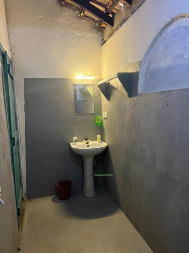 a bathroom with a white sink in a room at Cactus Arugambay in Arugam Bay