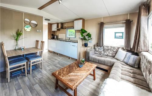 a living room with a couch and a table at 2 Bedroom Nice Home In Heinkenszand in Heinkensand