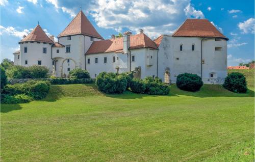 a large white castle with a grass yard at Beautiful Home In Kelemen With Sauna in Kelemen